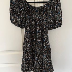 Darling , black with floral print dress can be worn off the shoulder. Size xs